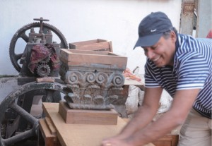 Hard labour: Sujjain Talwar brings an old piece of furniture back to life.