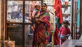 Woman_with_her_baby_outside_Indian_pharmacy
