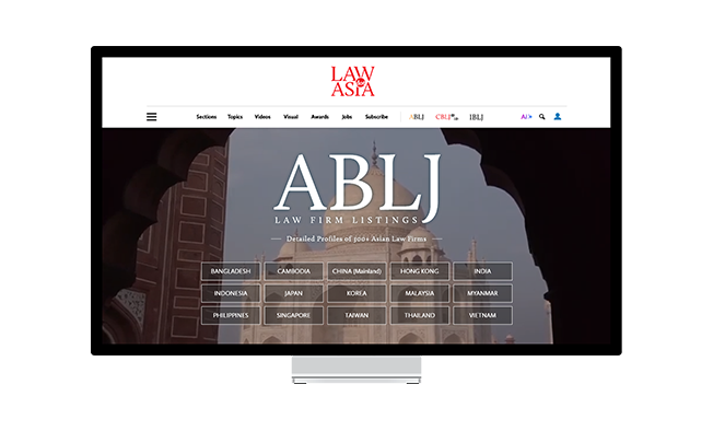 A monitor with a screenshot of the Asia Business Law Directory web page